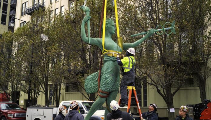 Spirit of Progress atop former Montgomery Ward building is taken down for repairs