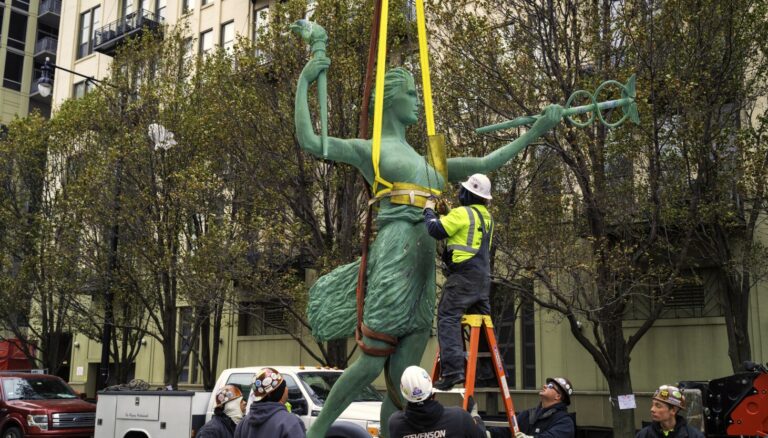 Spirit of Progress atop former Montgomery Ward building is taken down for repairs